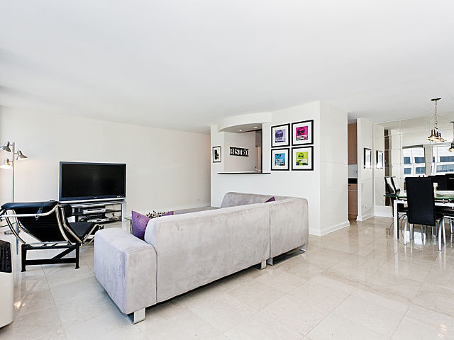 111 East Chestnut Street, Unit 16F Chicago, IL 60611 - Photo 4 of 20 a living room with furniture and a flat screen tv
