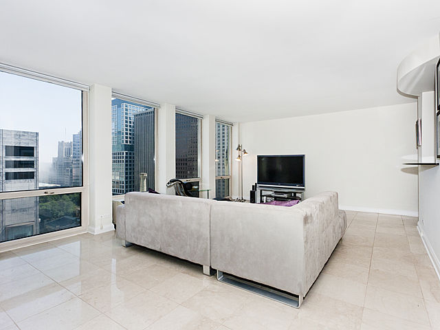 111 East Chestnut Street, Unit 16F Chicago, IL 60611 - Photo 5 of 20 a living room with furniture and a flat screen tv