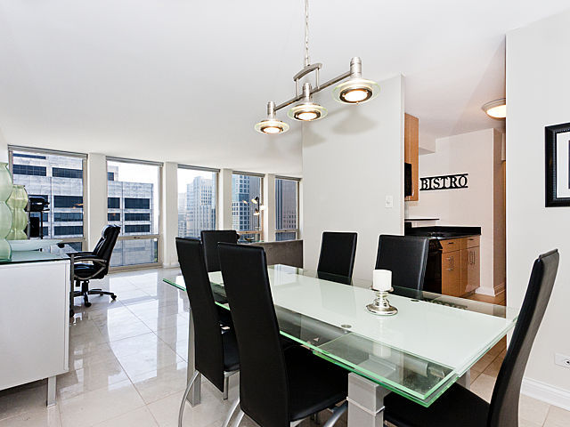111 East Chestnut Street, Unit 16F Chicago, IL 60611 - Photo 7 of 20 a view of a dining room with furniture window and outside view