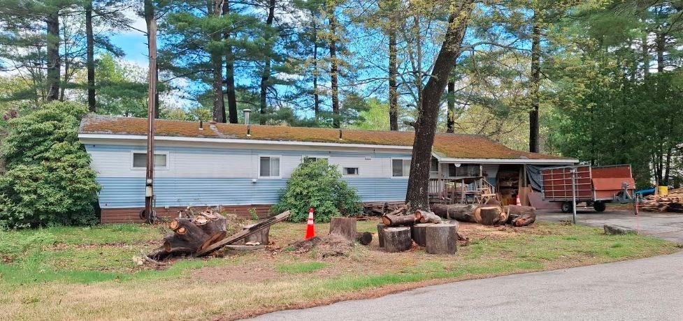 a view of a chair and table in backyard of the house