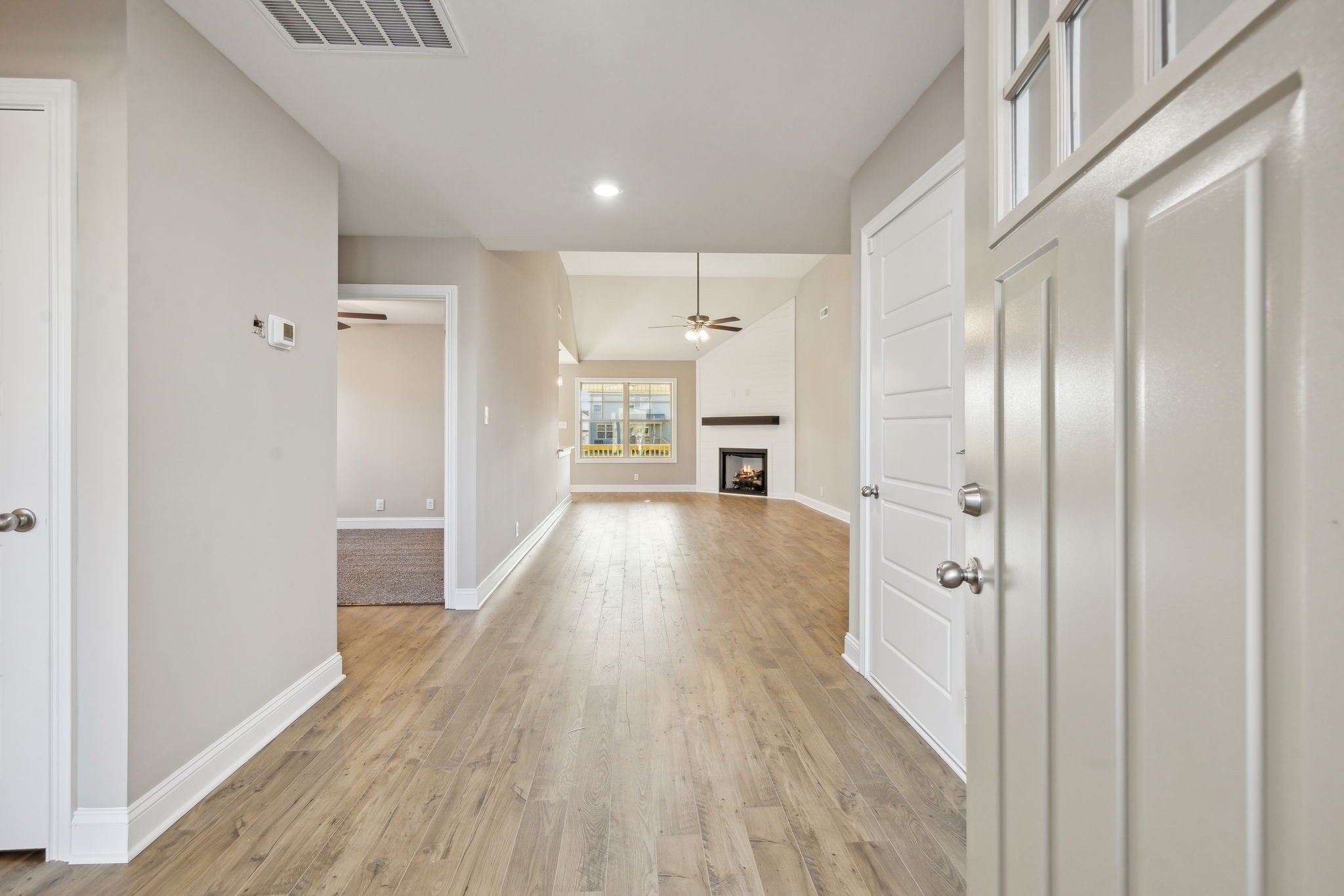 1271 Racker Drive Clarksville, TN 37043 - Photo 5 of 36 a view of a hallway with wooden floor stainless steel appliances and windows