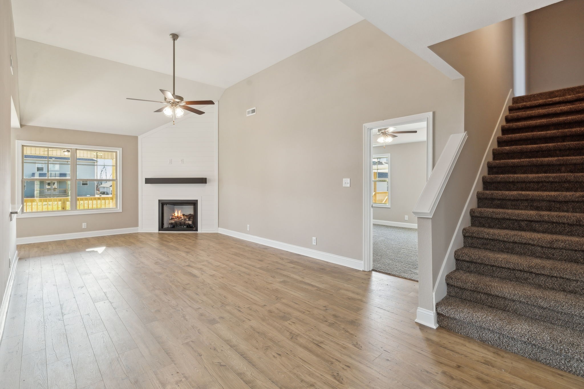 1271 Racker Drive Clarksville, TN 37043 - Photo 7 of 36 a view of an empty room with wooden floor fireplace and a window