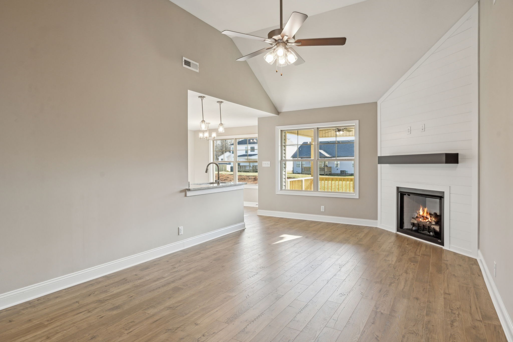 1271 Racker Drive Clarksville, TN 37043 - Photo 8 of 36 an empty room with windows fireplace and wooden floor