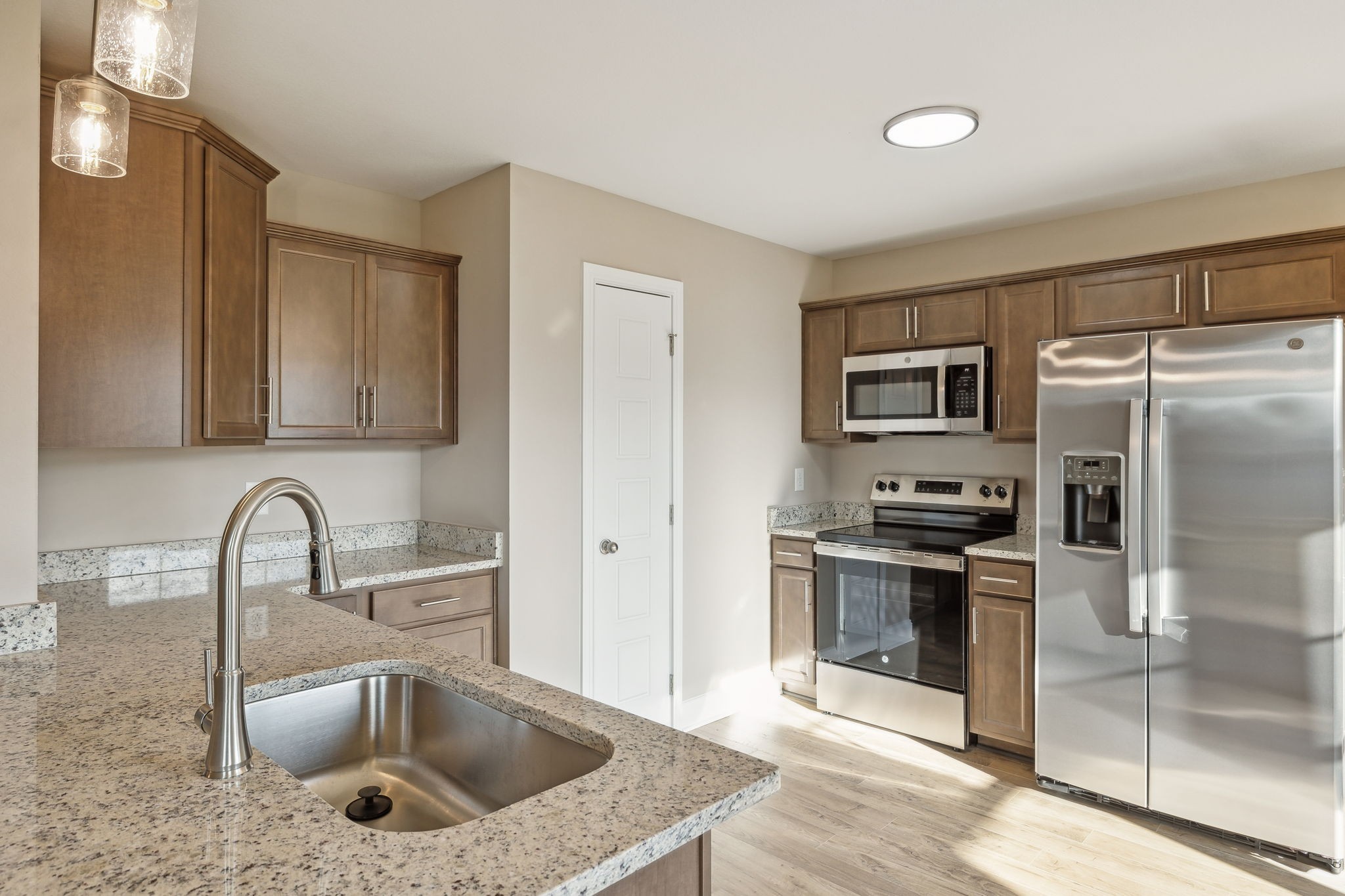 1271 Racker Drive Clarksville, TN 37043 - Photo 9 of 36 a kitchen with stainless steel appliances granite countertop a sink stove and refrigerator