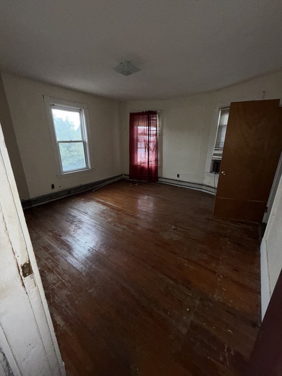 31 Rosedale Street Boston, MA 02124 - Photo 7 of 9 an empty room with wooden floor and windows