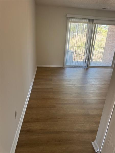 3288 Covington Drive Decatur, GA 30032 - Photo 2 of 15 a view of an empty room with wooden floor and a window