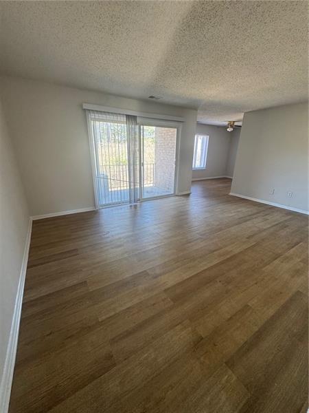3288 Covington Drive Decatur, GA 30032 - Photo 3 of 15 wooden floor in an empty room with a window