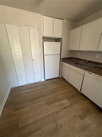 a kitchen with a refrigerator and cabinets
