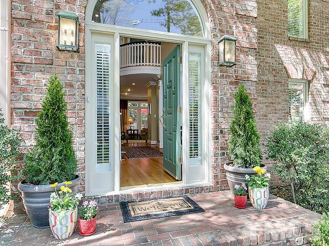 7905 Ogden Court Raleigh, NC 27613 - Photo 1 of 25 a view of a path along with brick wall and potted plants