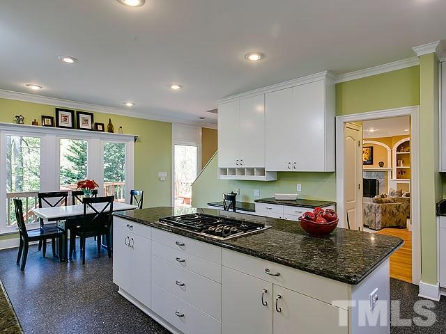 7905 Ogden Court Raleigh, NC 27613 - Photo 6 of 25 a kitchen with granite countertop a sink and white cabinets