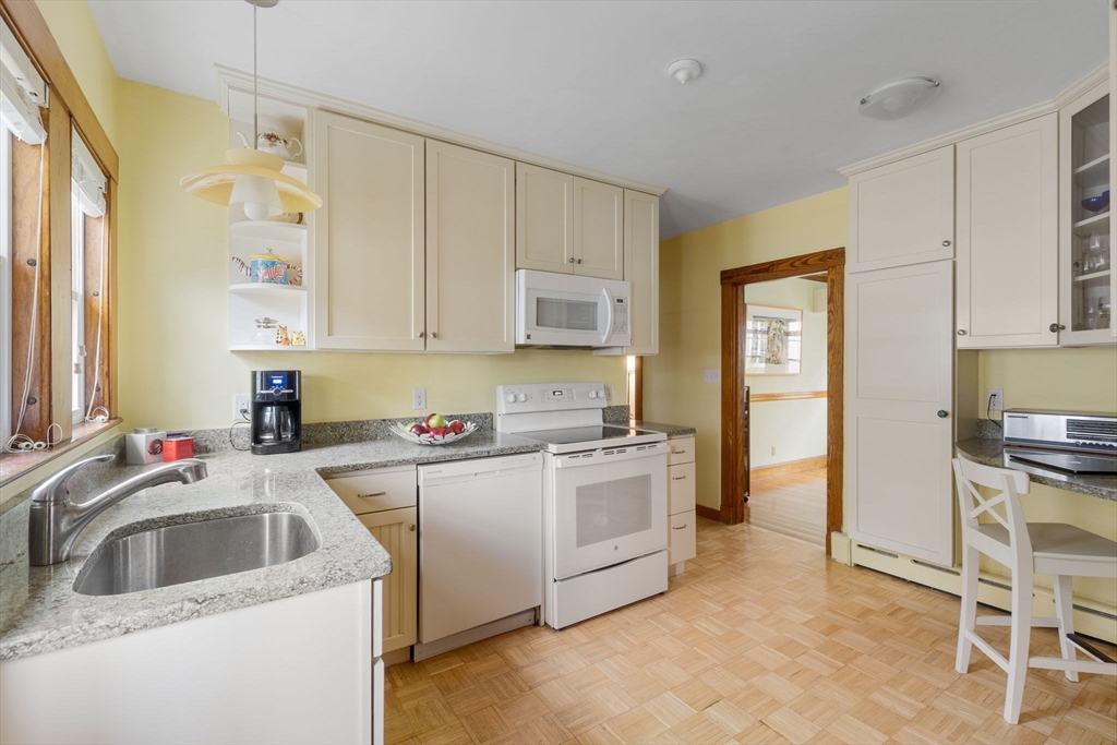 59 Chesbrough Road Boston, MA 02132 - Photo 12 of 27 a kitchen that has a sink and a stove in it