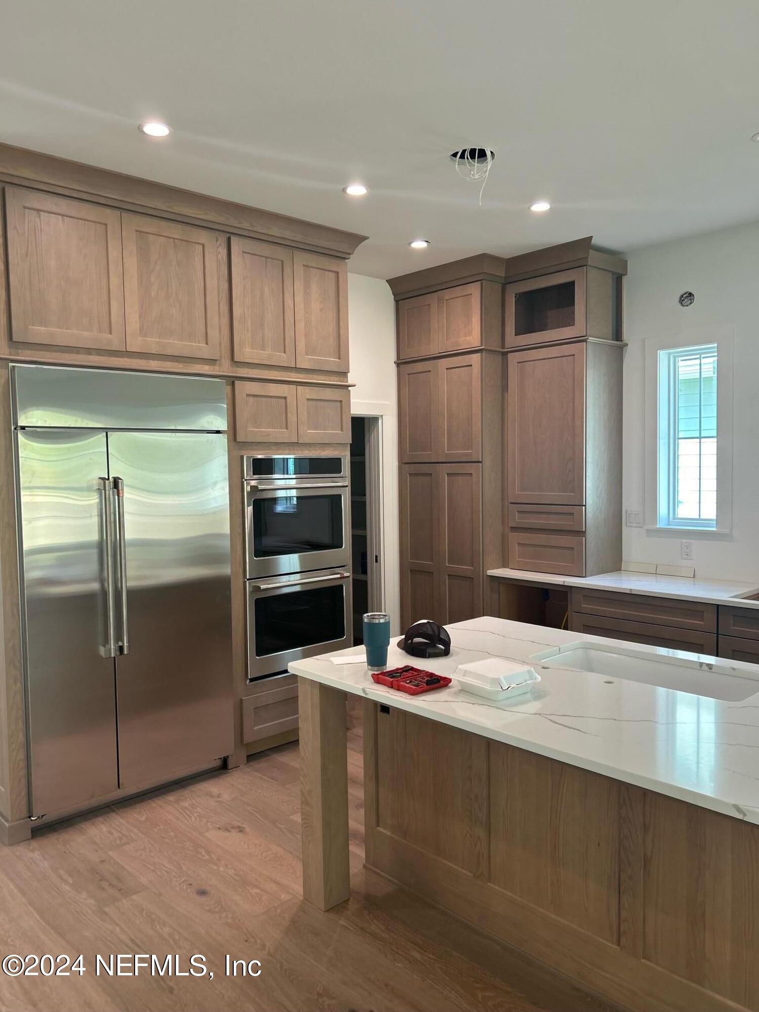 372 Ridgeway Road St. Augustine, FL 32080 - Photo 21 of 38 a kitchen with stainless steel appliances kitchen island granite countertop a refrigerator and a sink