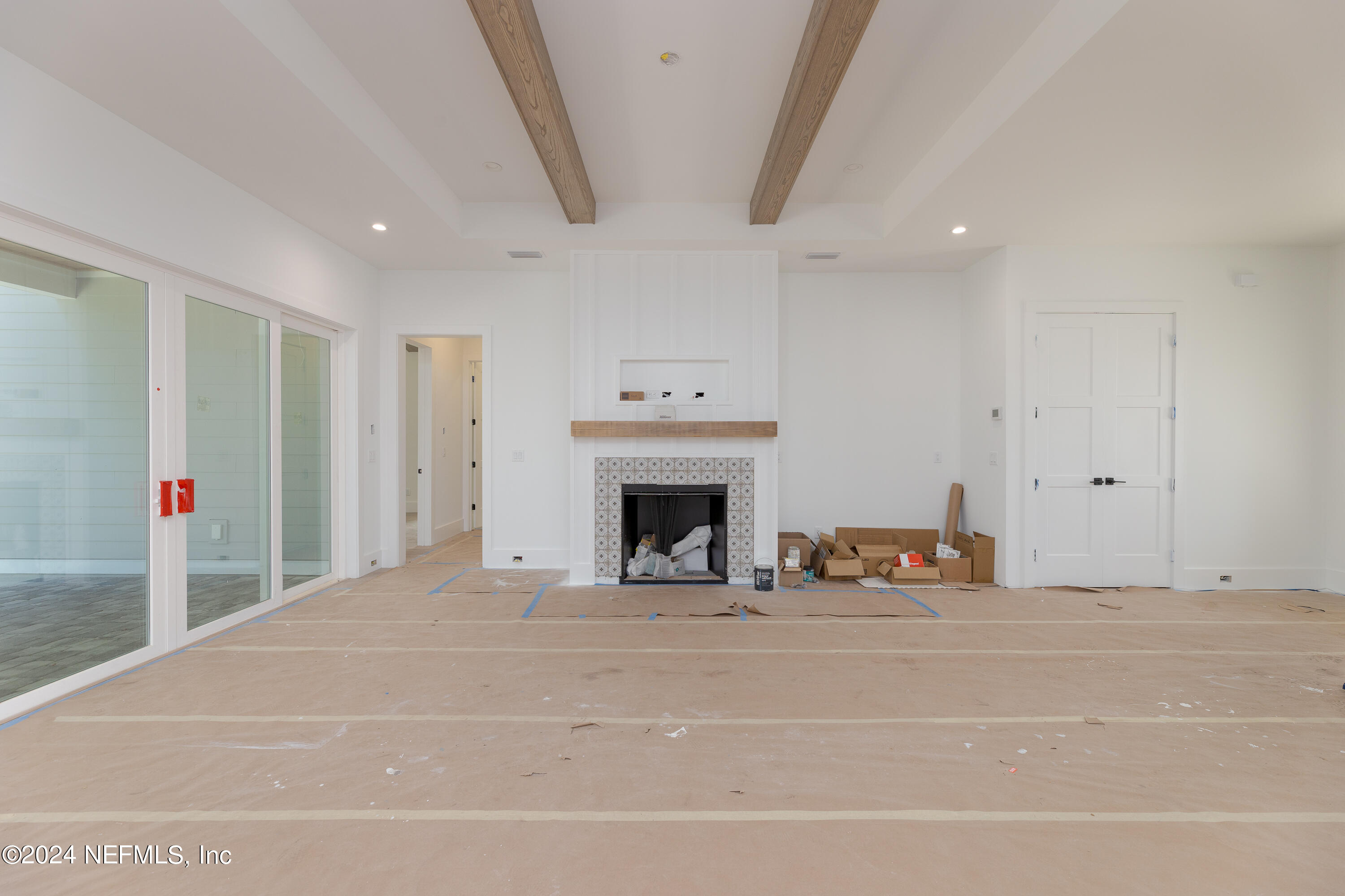 372 Ridgeway Road St. Augustine, FL 32080 - Photo 23 of 38 a view of an empty room with a fireplace and a window