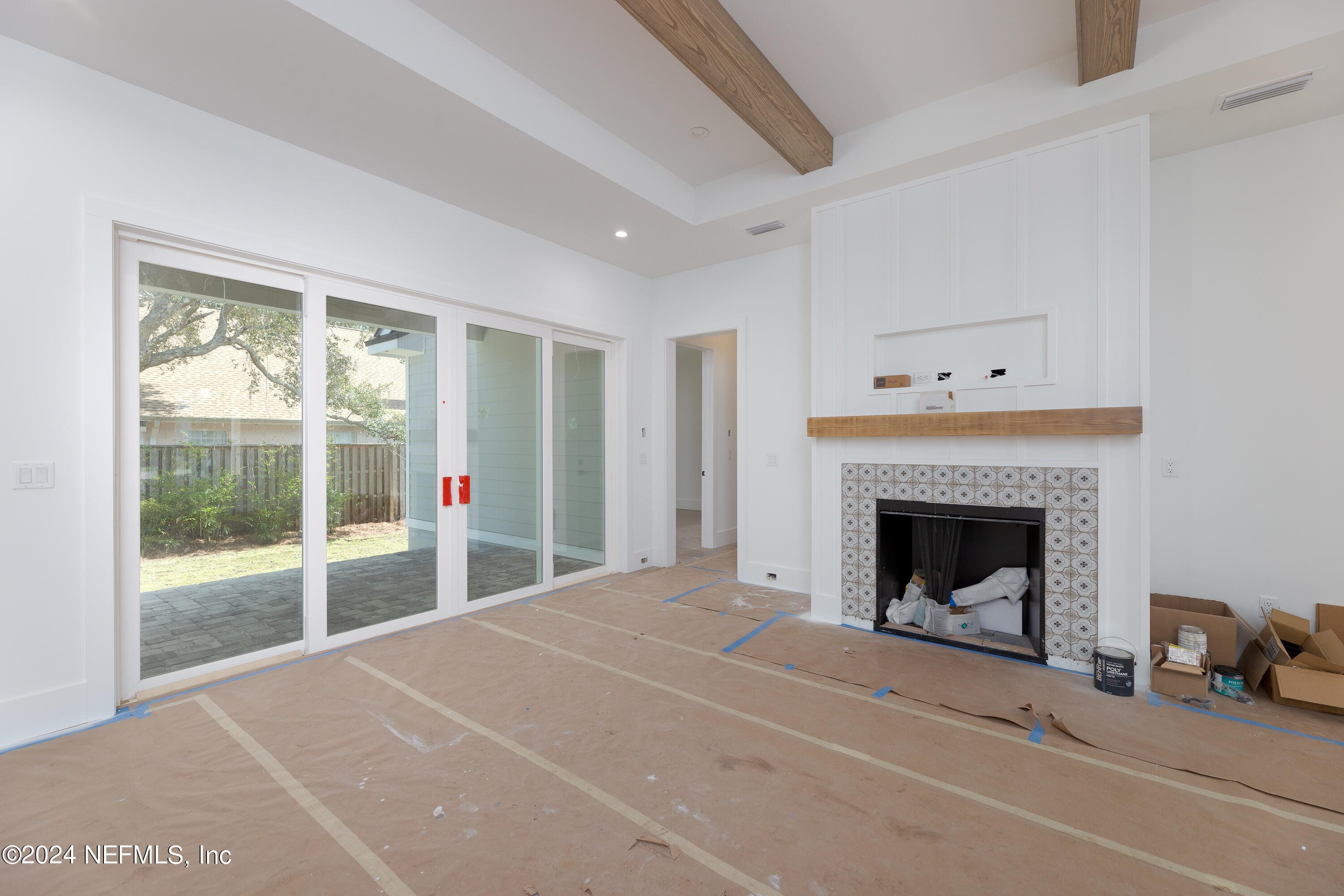 372 Ridgeway Road St. Augustine, FL 32080 - Photo 24 of 38 a view of an empty room with a fireplace and a window