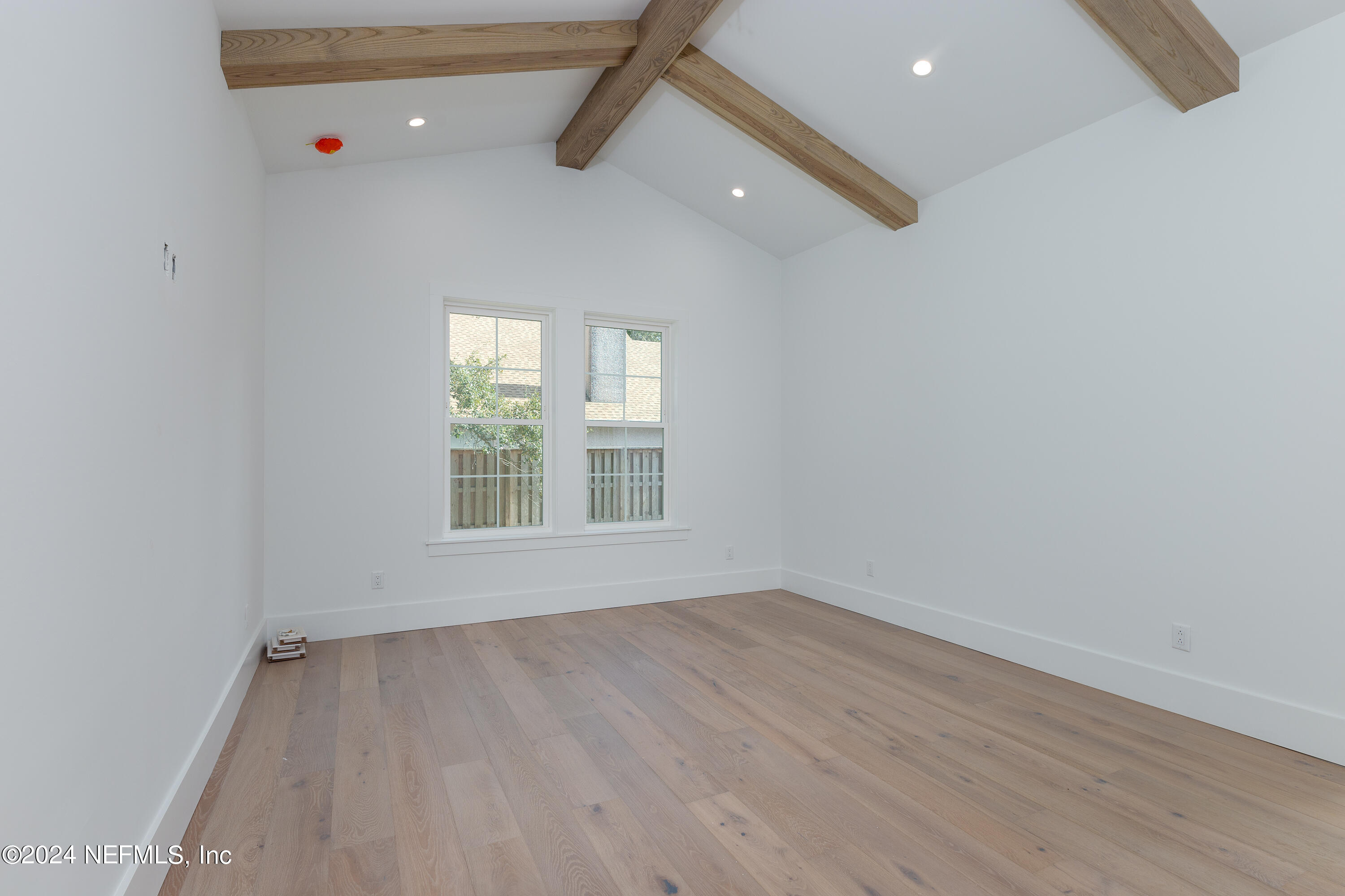 372 Ridgeway Road St. Augustine, FL 32080 - Photo 26 of 38 wooden floor in an empty room with a window