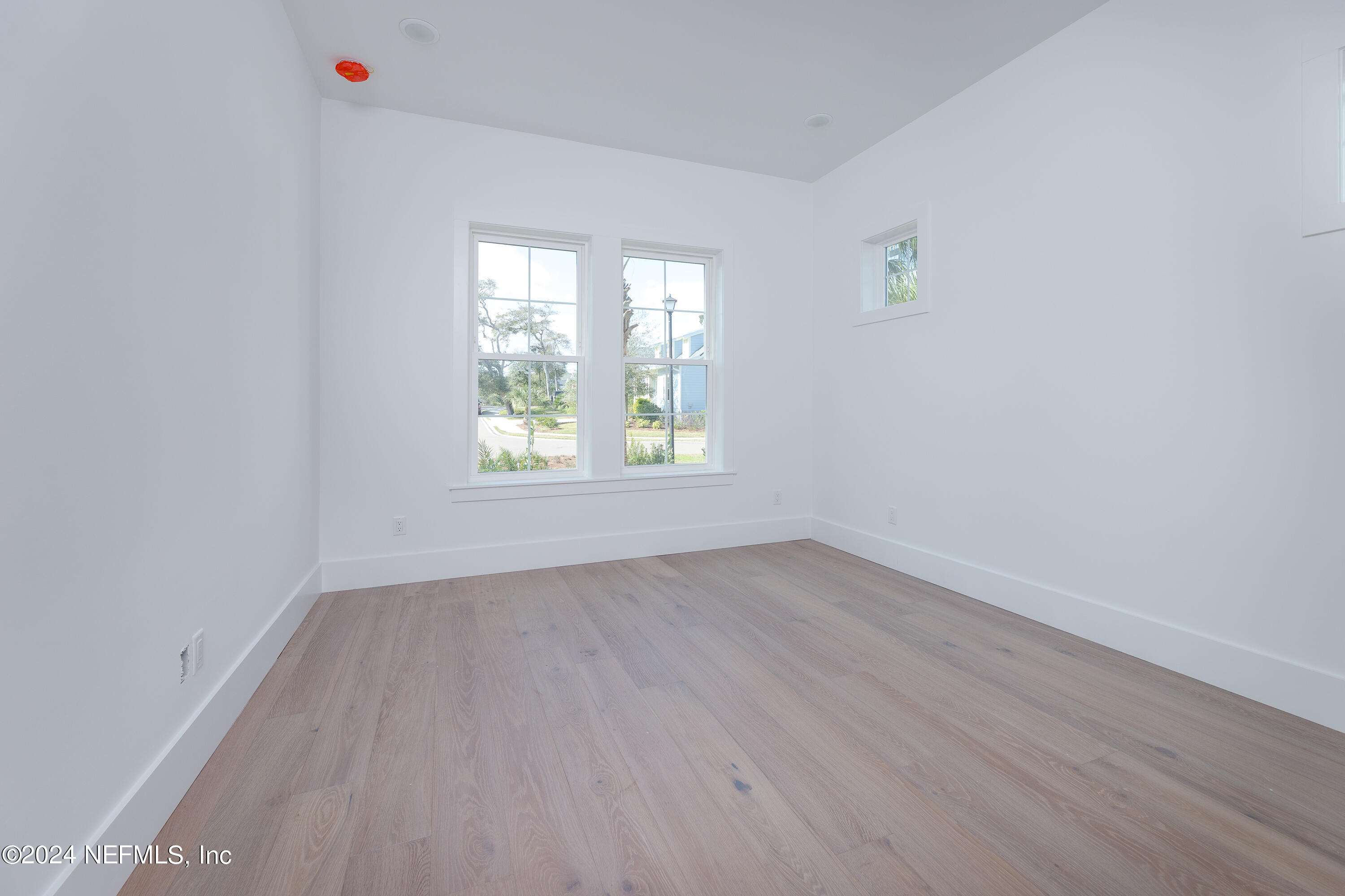 372 Ridgeway Road St. Augustine, FL 32080 - Photo 30 of 38 an empty room with wooden floor and windows
