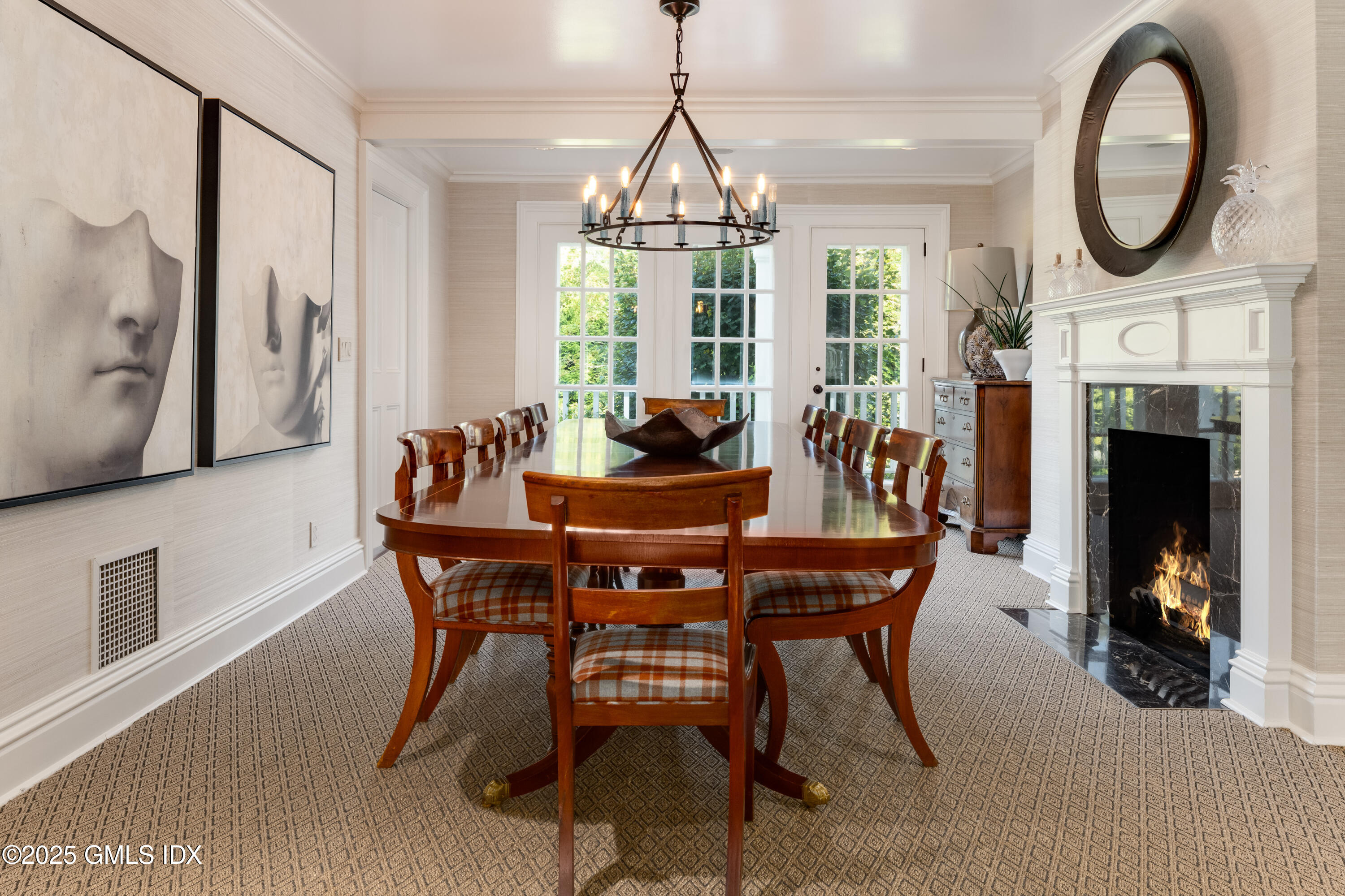 411 Stanwich Road Greenwich, CT 06830 - Photo 11 of 36 a dining room with furniture a fireplace and a chandelier