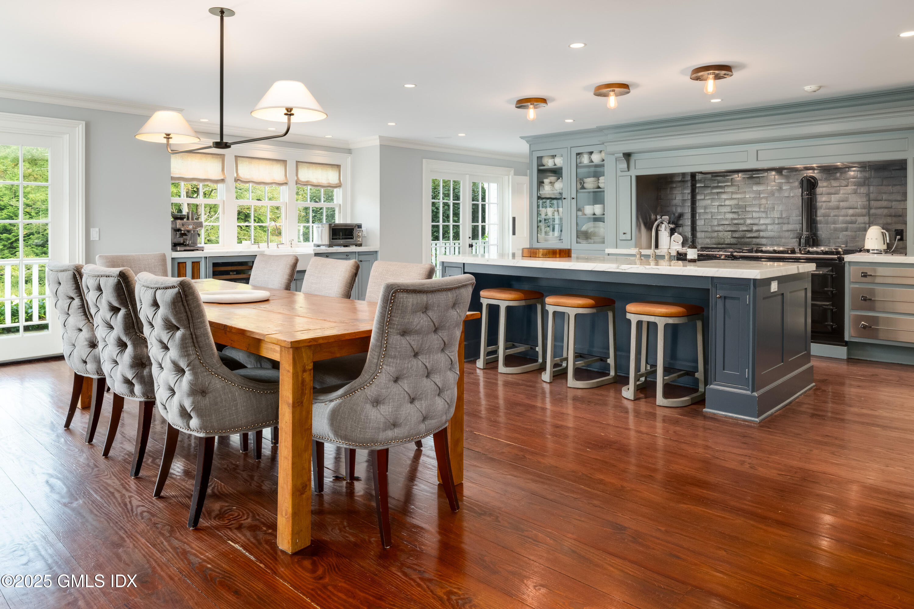 411 Stanwich Road Greenwich, CT 06830 - Photo 13 of 36 a dining room with furniture window wooden floor and a chandelier