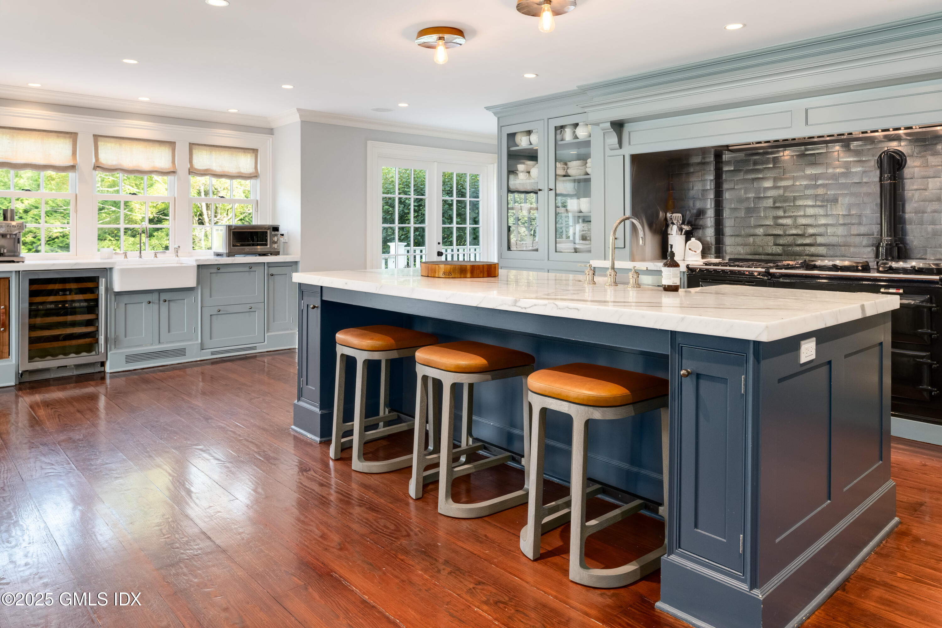 411 Stanwich Road Greenwich, CT 06830 - Photo 14 of 36 a kitchen with stainless steel appliances a table and chairs in it