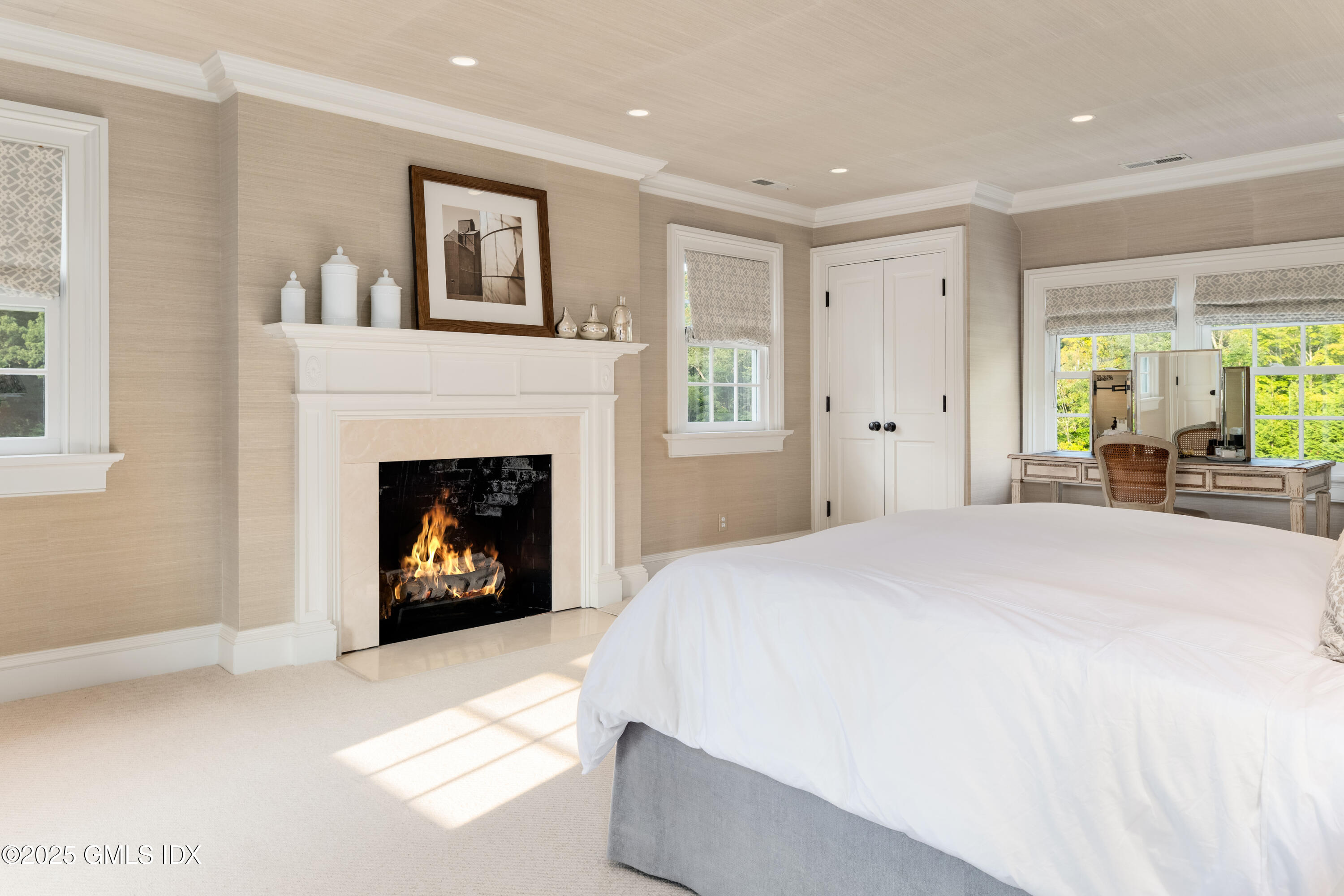411 Stanwich Road Greenwich, CT 06830 - Photo 19 of 36 a spacious bedroom with a large bed and a fireplace