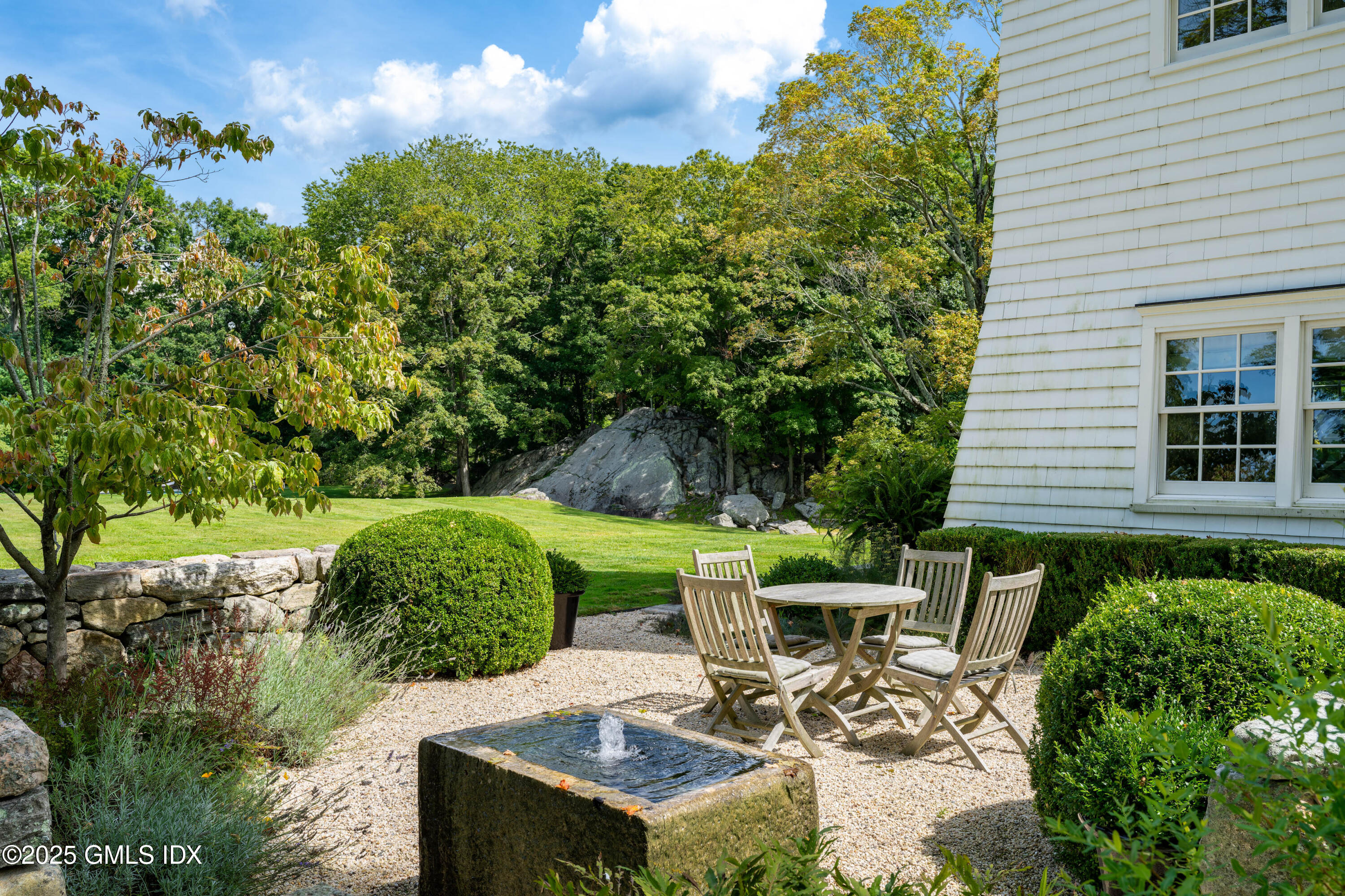 411 Stanwich Road Greenwich, CT 06830 - Photo 31 of 36 a view of a patio with table and chairs and potted plants