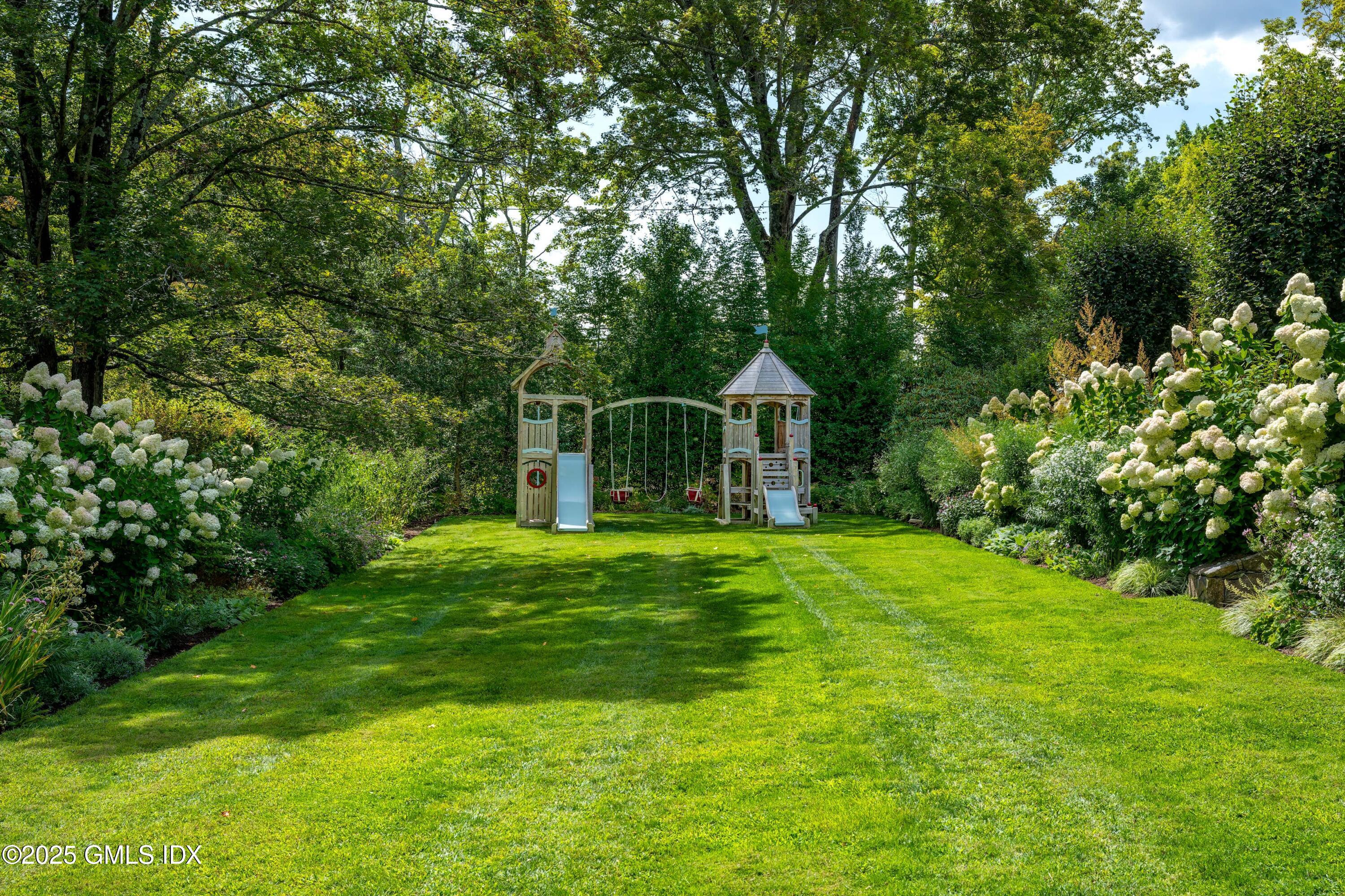 411 Stanwich Road Greenwich, CT 06830 - Photo 32 of 36 a front view of a house with a yard