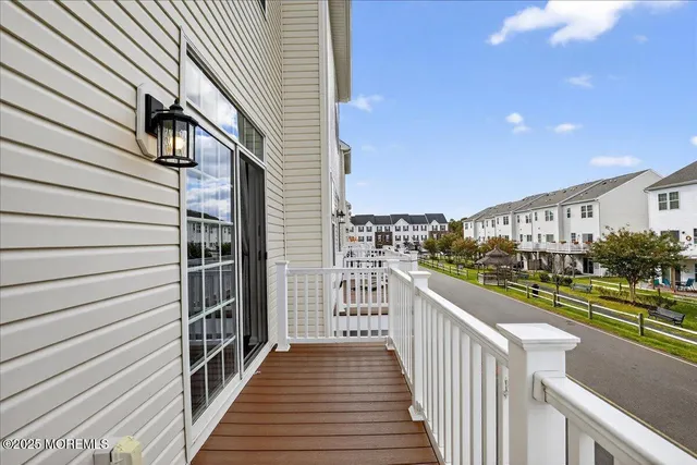 a view of a livingroom with a window and wooden floor