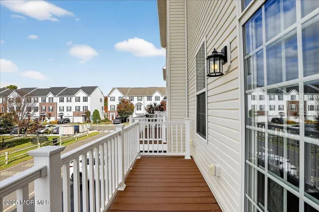 a view of a livingroom with wooden floor and a ceiling fan