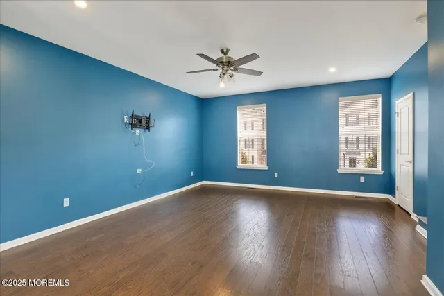 a view of a livingroom with furniture stairs and a chandelier fan