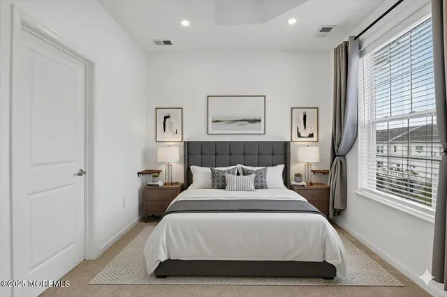 a bathroom with a granite countertop double vanity sink and a mirror