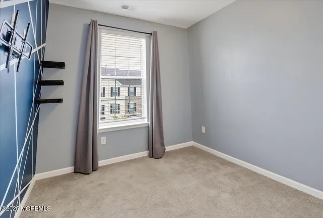 a view of a chair and table in backyard of the house