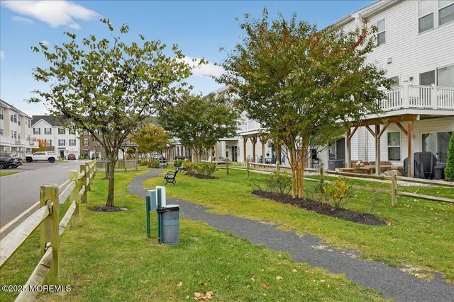 a view of a house with a yard and potted plants