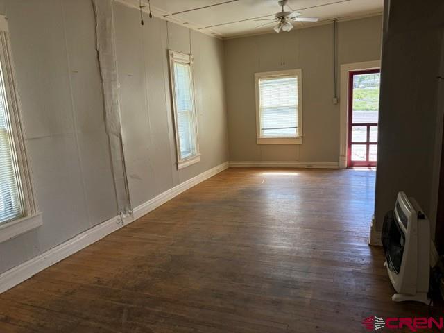 116 South Mary Street Ridgway, CO 81432 - Photo 7 of 23 an empty room with wooden floor and windows