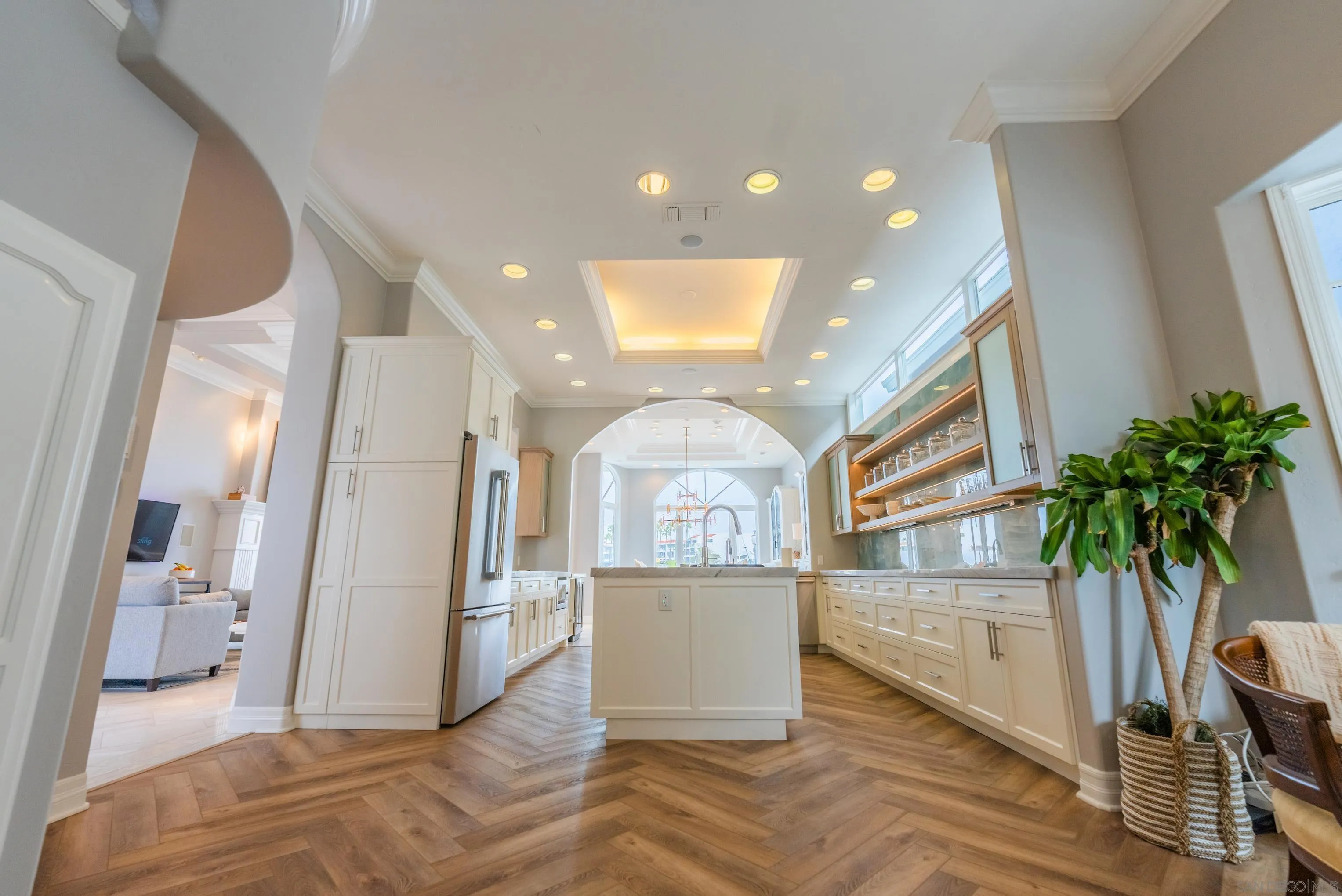 29 The Point Coronado, CA 92118 - Photo 18 of 52 a view of a hallway with wooden floor and a potted plant