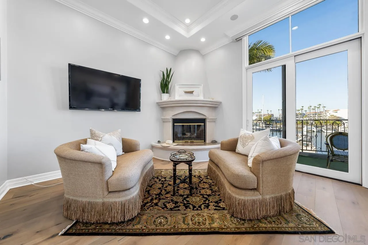 29 The Point Coronado, CA 92118 - Photo 30 of 52 a living room with furniture a flat screen tv and a fireplace