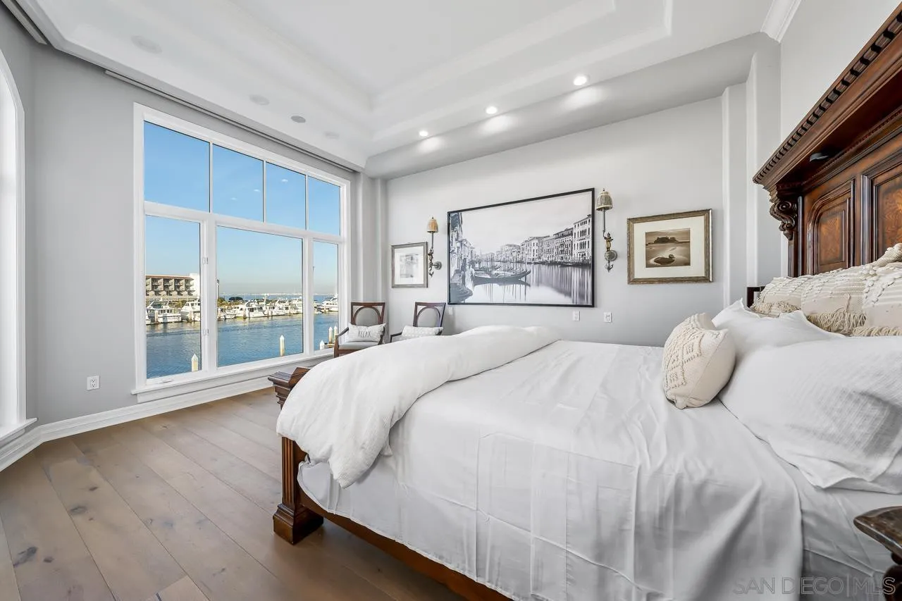 29 The Point Coronado, CA 92118 - Photo 31 of 52 a bedroom with a large bed and a large window