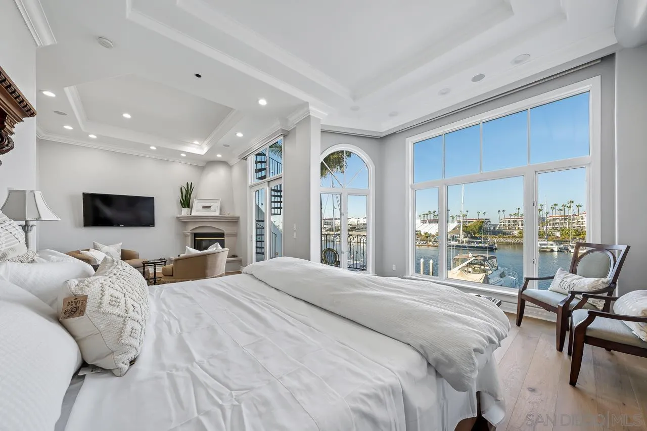 29 The Point Coronado, CA 92118 - Photo 32 of 52 a bedroom with a bed window and a flat screen tv