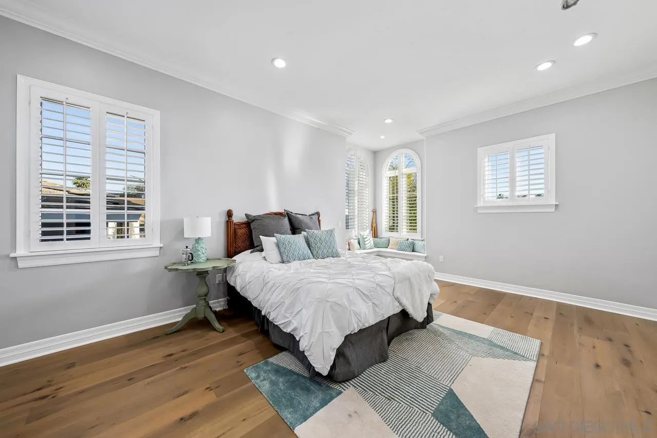 29 The Point Coronado, CA 92118 - Photo 35 of 52 a spacious bedroom with a bed and wooden floor