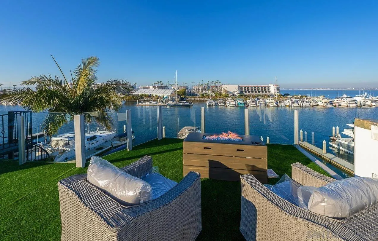 29 The Point Coronado, CA 92118 - Photo 39 of 52 a view of a swimming pool and lounge chairs in back yard of the house