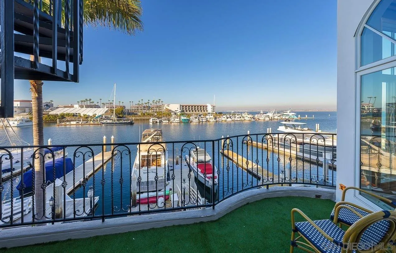 29 The Point Coronado, CA 92118 - Photo 48 of 52 a view of a balcony with a floor to ceiling window and wooden fence