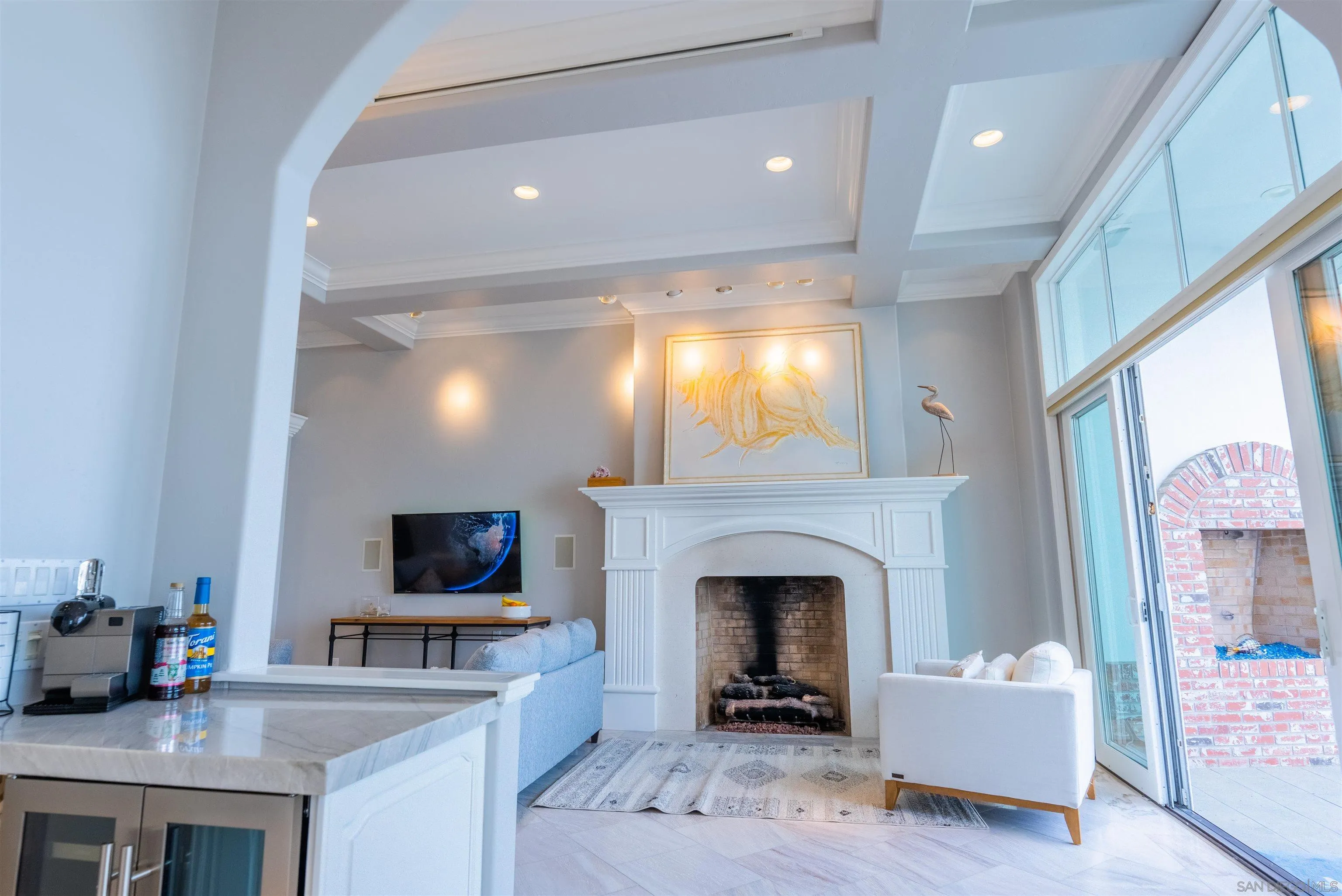 29 The Point Coronado, CA 92118 - Photo 7 of 52 a living room with furniture a flat screen tv and a fireplace