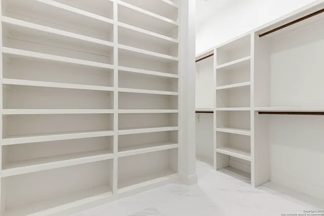 a view of a living room with wooden floor and stairs