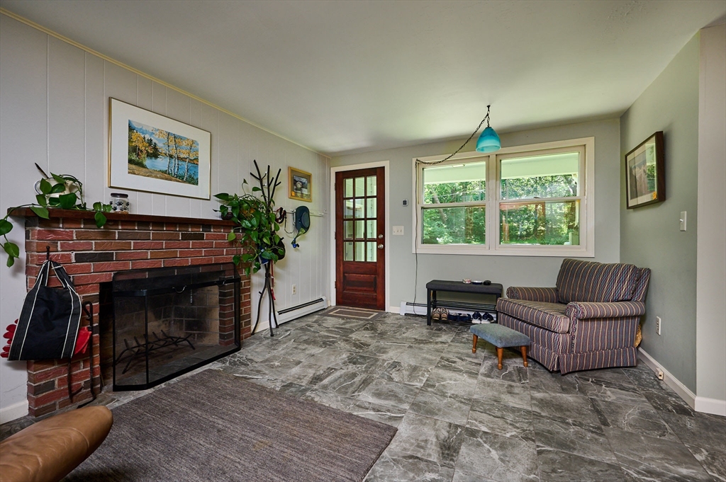 21 Arnold Road Pelham, MA 01002 - Photo 2 of 36 a living room with furniture a window and a fireplace