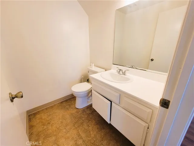 a bathroom with a sink toilet and vanity