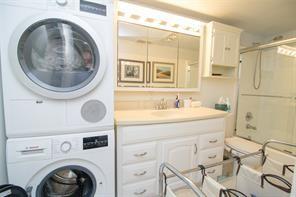 298 Southeast 6th Avenue, Unit 9 Pompano Beach, FL 33060 - Photo 15 of 22 a bathroom with a sink a washer and dryer