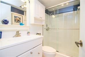 298 Southeast 6th Avenue, Unit 9 Pompano Beach, FL 33060 - Photo 17 of 22 a bathroom with a sink a toilet and shower