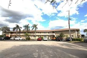 a city street lined with parked cars and buildings