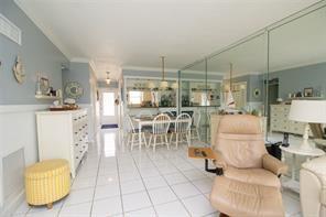 298 Southeast 6th Avenue, Unit 9 Pompano Beach, FL 33060 - Photo 22 of 22 a living room with lots of furniture and a chandelier