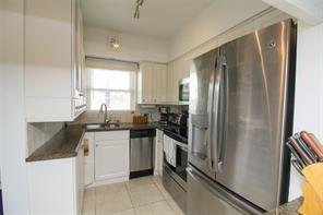 298 Southeast 6th Avenue, Unit 9 Pompano Beach, FL 33060 - Photo 6 of 22 a kitchen with a refrigerator sink and stove