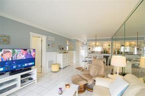 298 Southeast 6th Avenue, Unit 9 Pompano Beach, FL 33060 - Photo 10 of 22 a living room with furniture and a flat screen tv